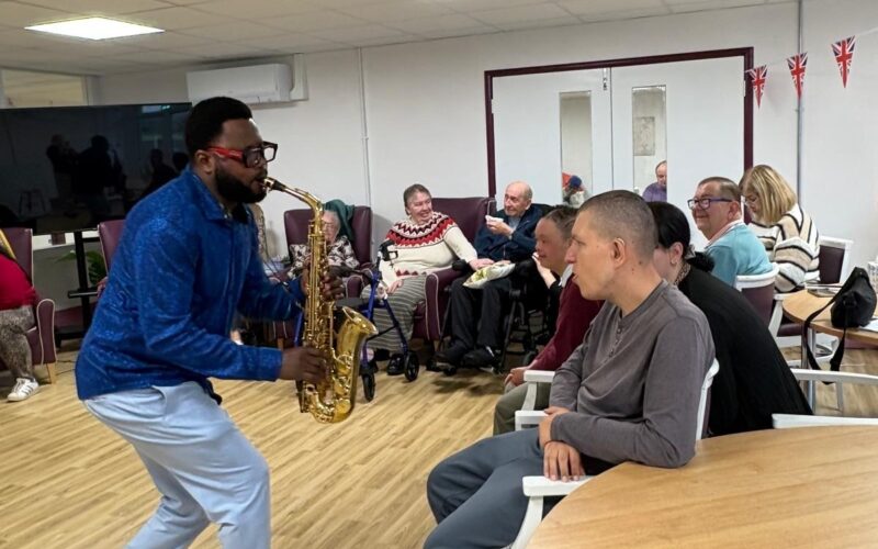 Mike playing the saxophone for ECL customers.