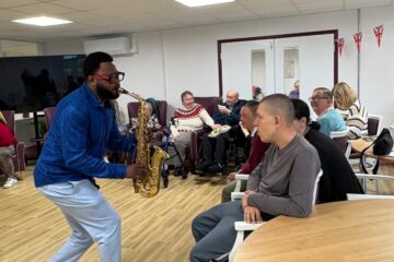 Mike playing the saxophone for ECL customers.