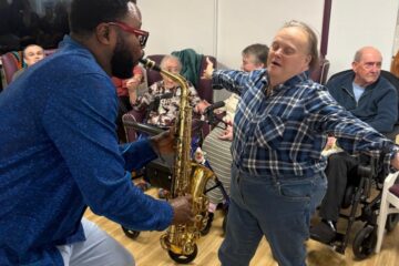 ECL customer dancing to Mike Aremu's music.