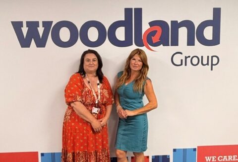 Recruitment Manager, Claire and ECL Job Broker, Jenny price standing in front of the Woodland Group logo