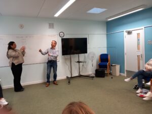 Saydi and BSL tutor showcasing their British Sign Language conversation to the class