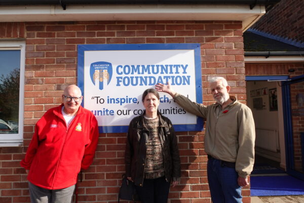 Three Older People customers standing outside the community foundation
