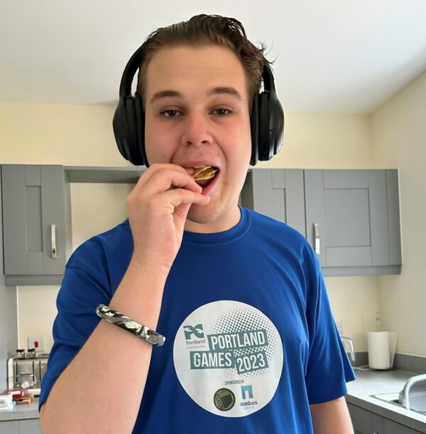 A young boy eating a biscuit.