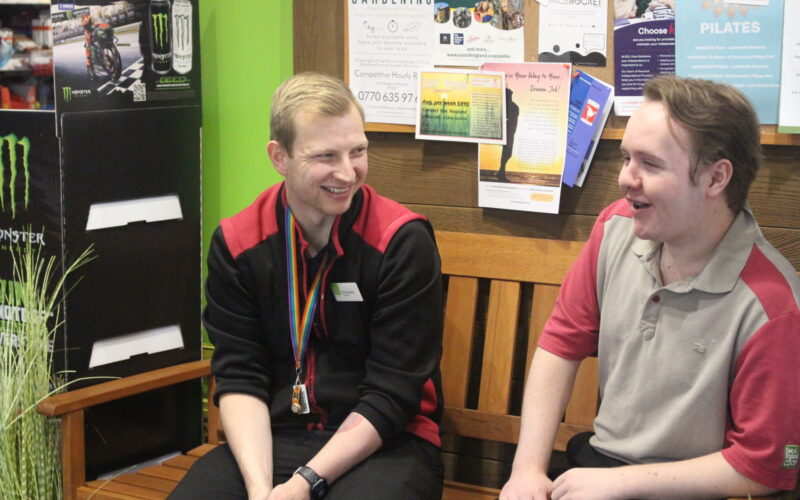 Two men talking at work.
