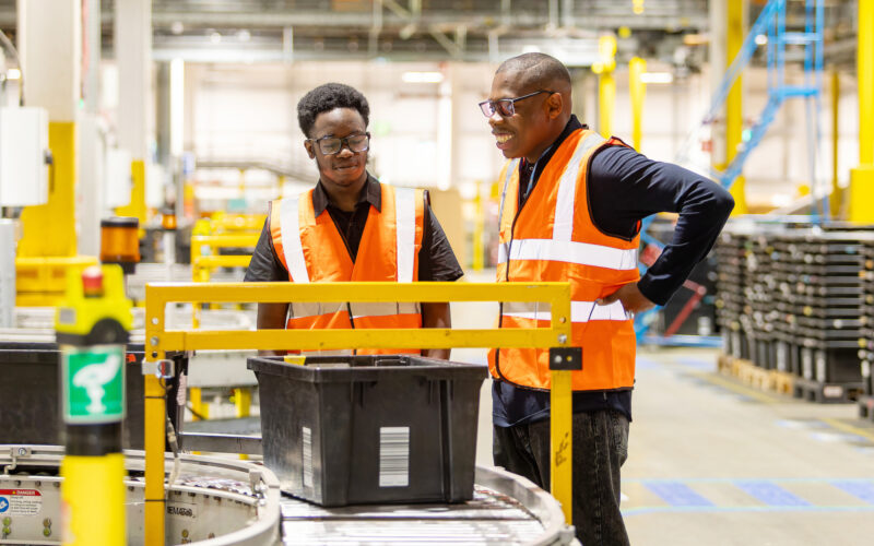 Graduates Timi and Hayden at work in Amazon's LCY2 site