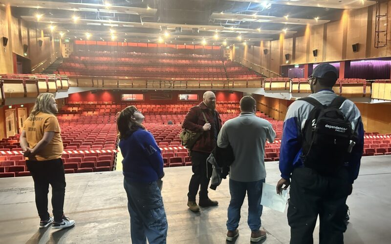 Group of young adults taking a tour of Cliffs Pavilion theatre.