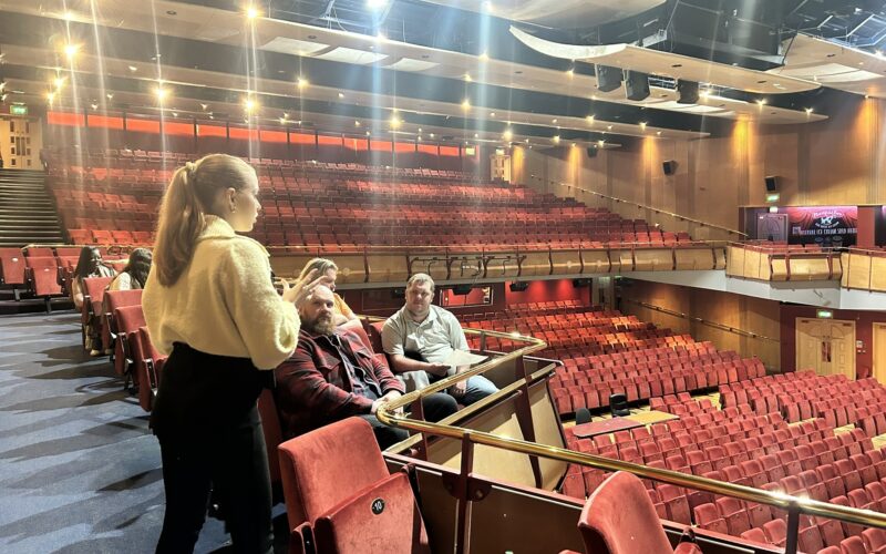 Group of young adults taking a tour of Cliffs Pavilion theatre.