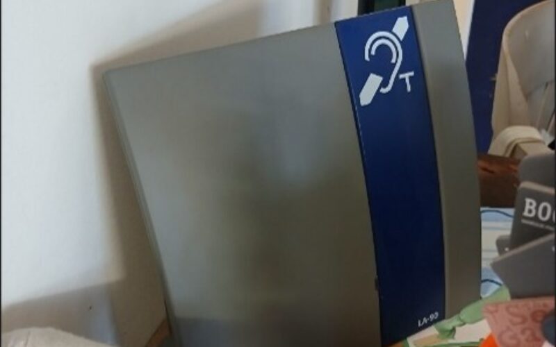 Photo of an induction loop placed on the counter by the till of the bookshop.