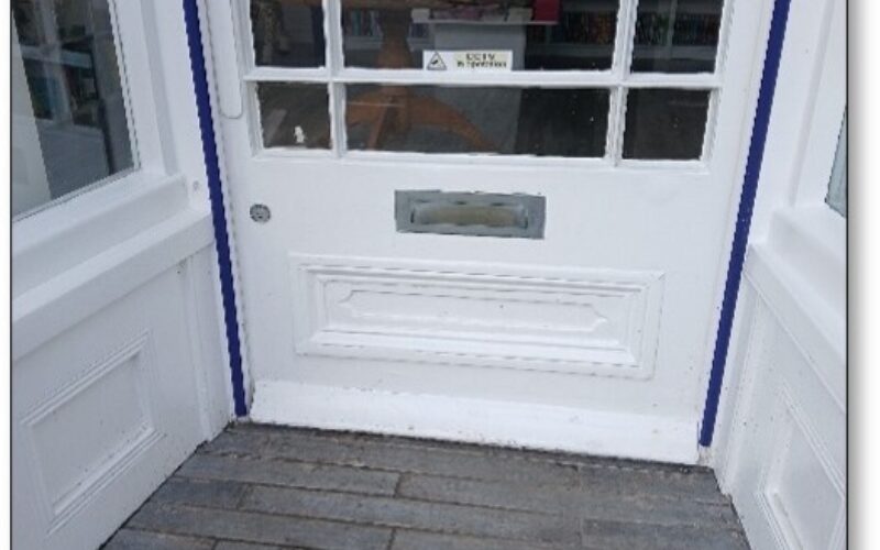 Exterior photo of the shop's entrance with blue colour contrasts for the visually impaired.