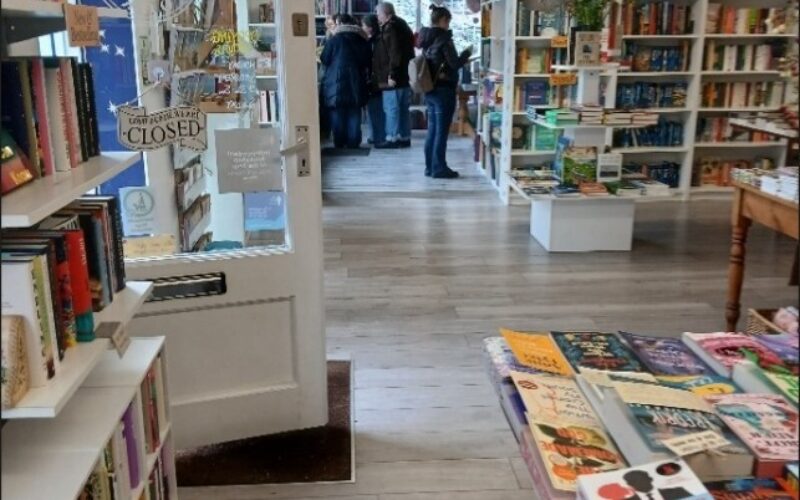 Interior photo of Maldon Books after the accessibility improvements - view from the right hand side of the store showing the inside of the door and a display table.