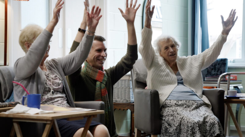 Oliver Mann with two customers exercising their hands