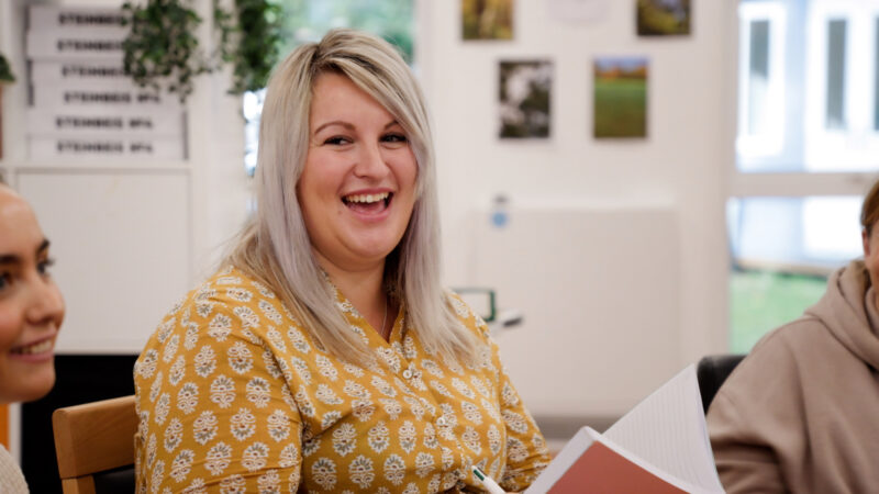 Jess Shorey laughing during a team meeting