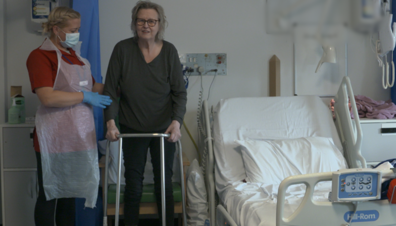 ECL Community Care Assistant Kelly Parums helping a patient on Birch Ward mobilise following surgery.