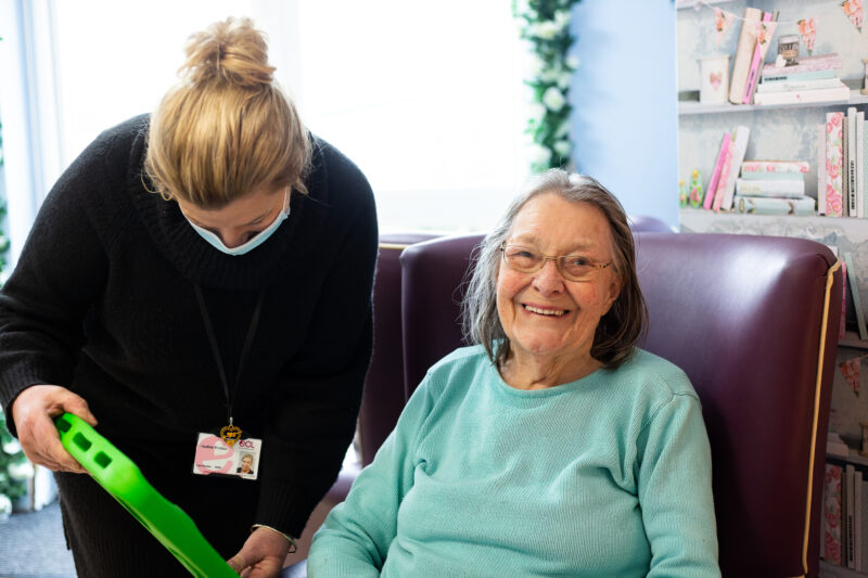 Carer helping happy customer