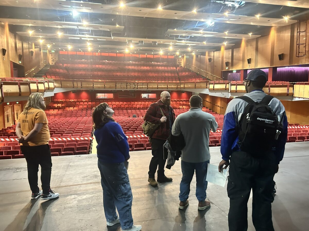 Group of young adults taking a tour of Cliffs Pavilion theatre.