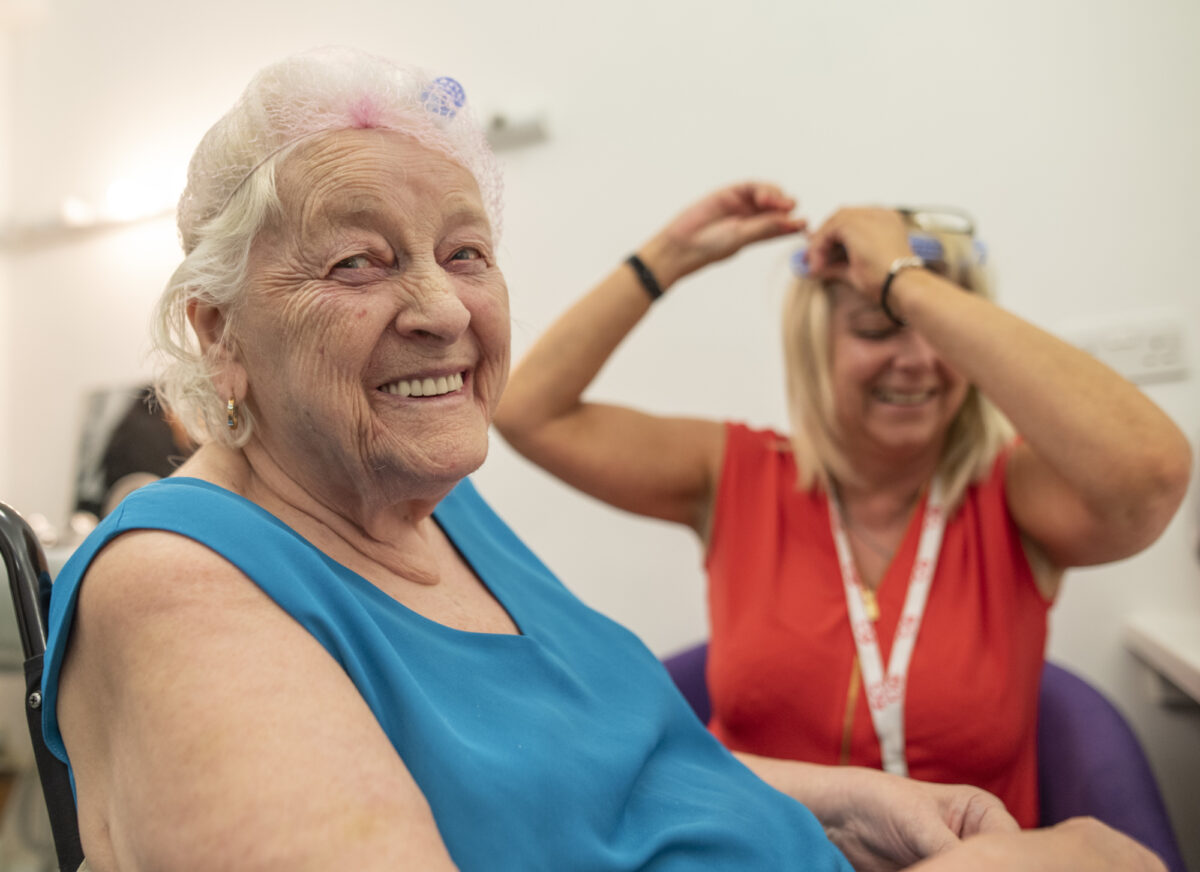 Older person getting their hair cut.