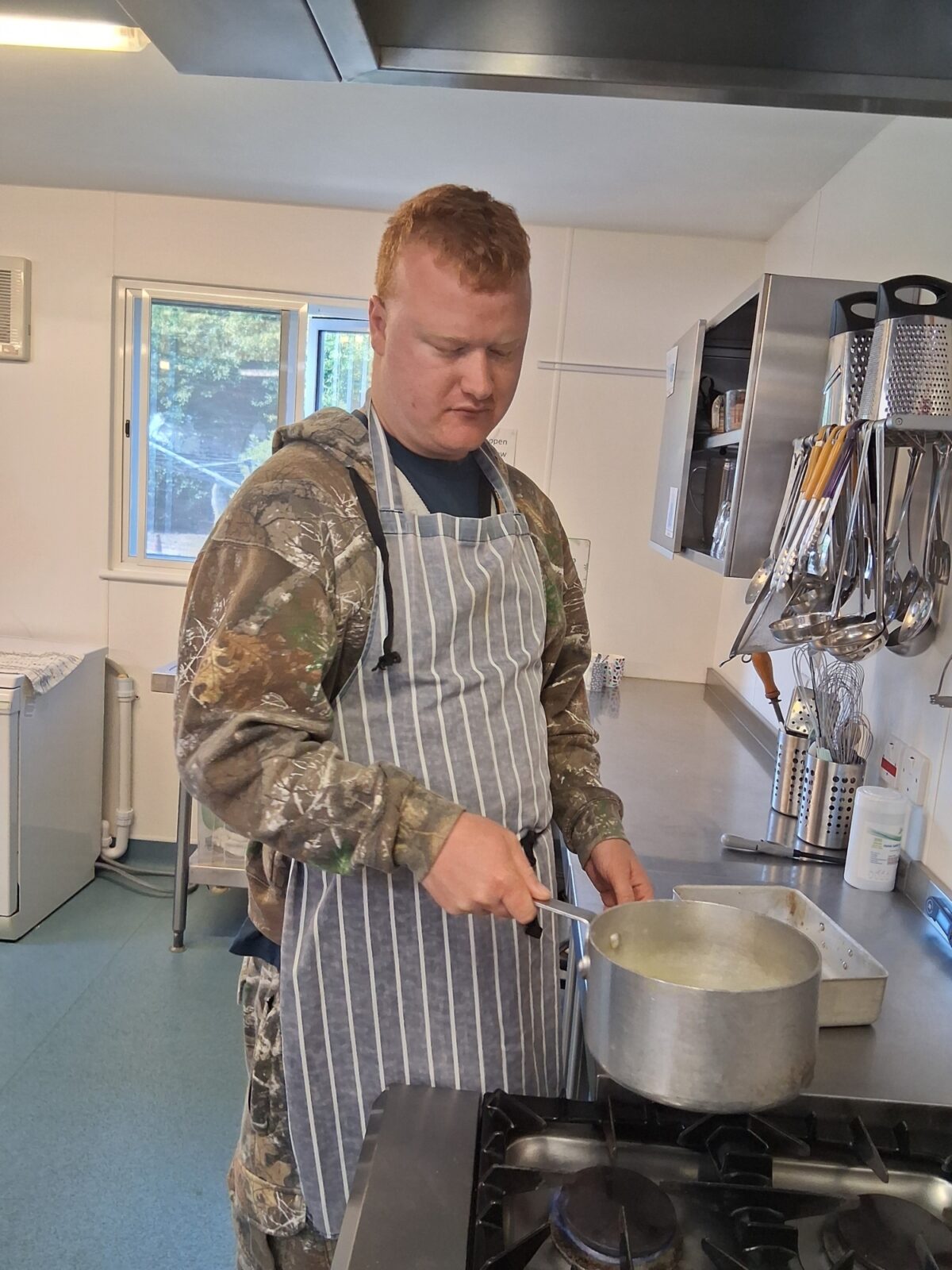 You man in a kitchen cooking