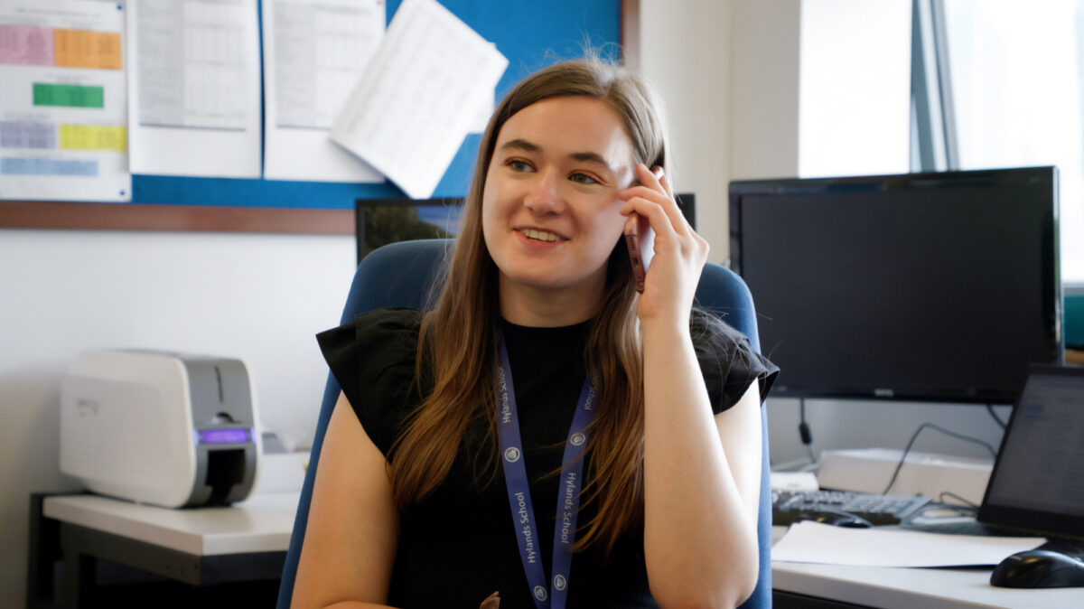 Photo of Maisie speaking on the telephone