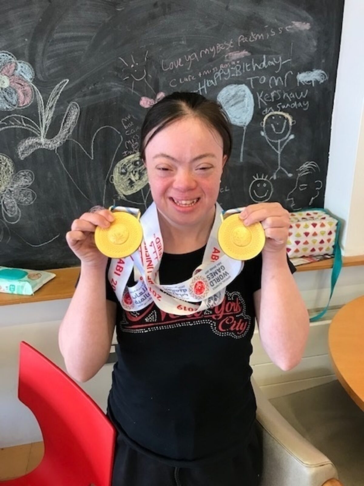 ECL customer Rosa showing off her gold medals