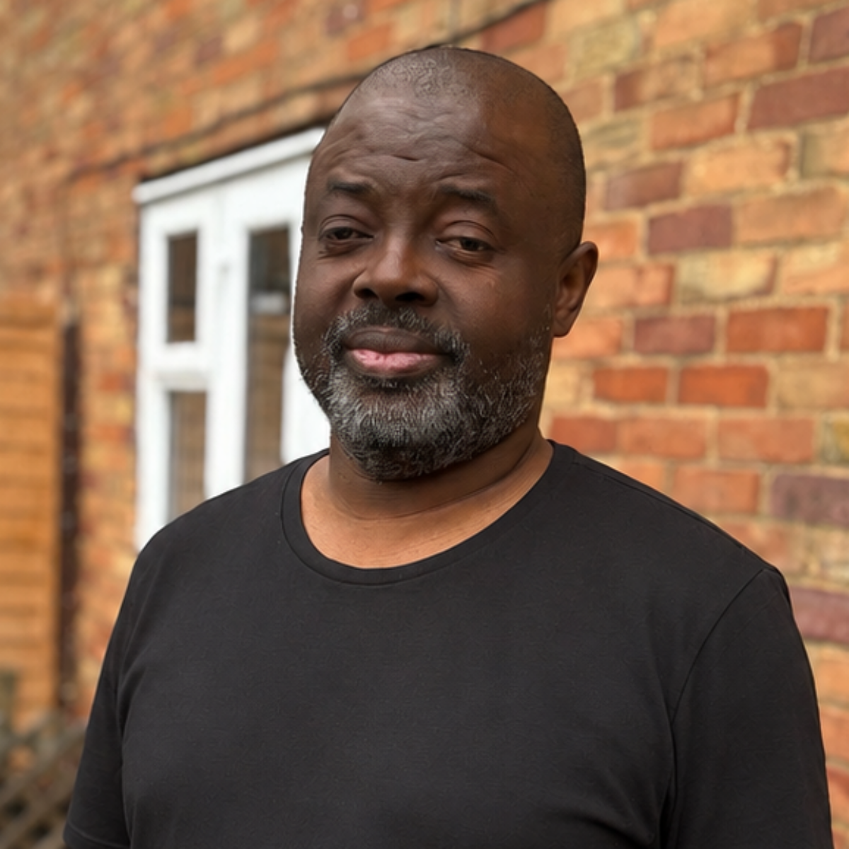 Man standing outside a house.
