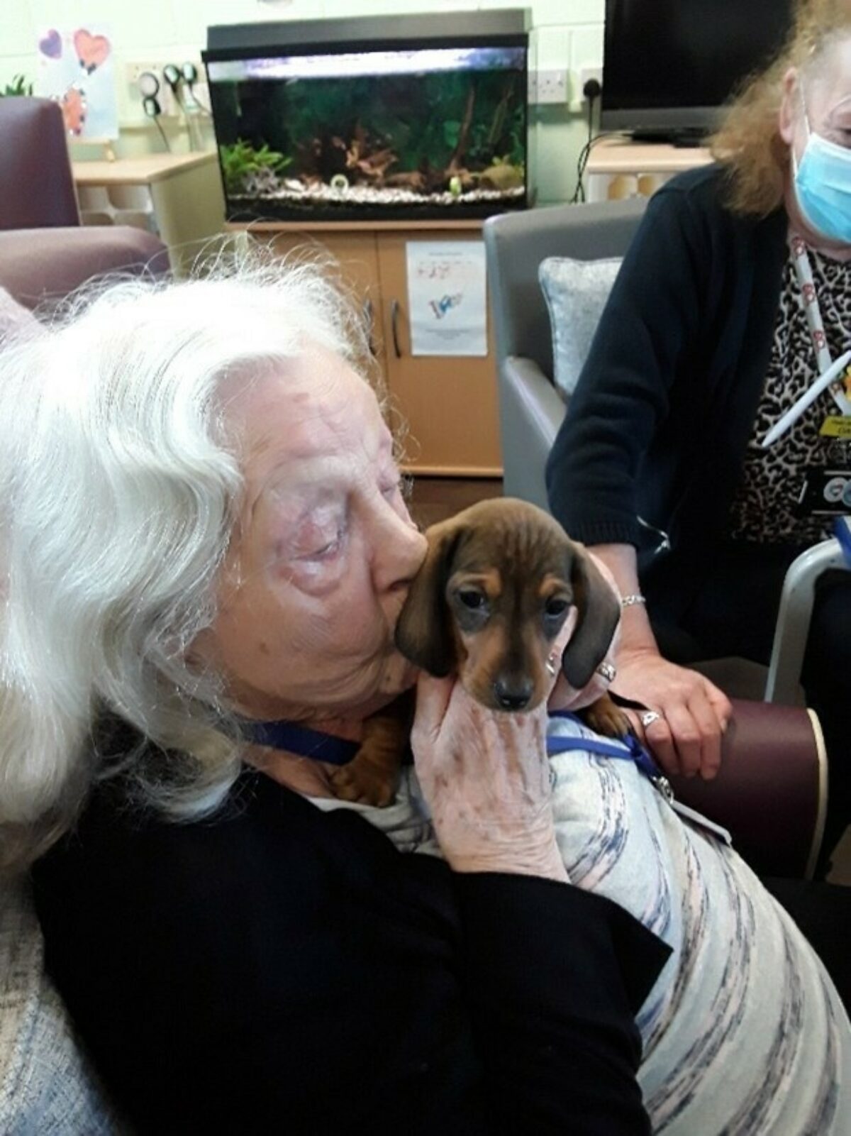 An elderly lady with a dog.