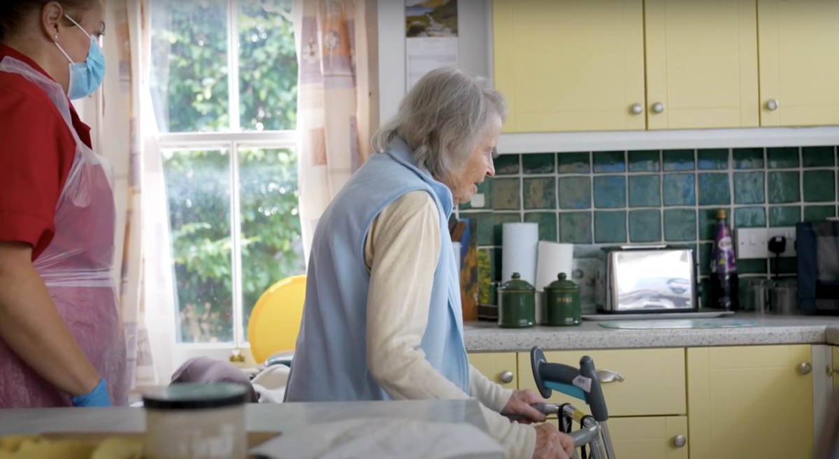 An elderly woman in a kitchen