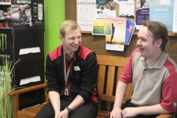 Two men talking at work.