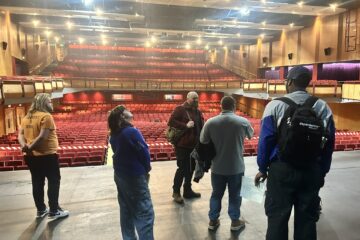 Group of young adults taking a tour of Cliffs Pavilion theatre.