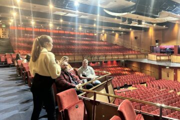 Group of young adults taking a tour of Cliffs Pavilion theatre.