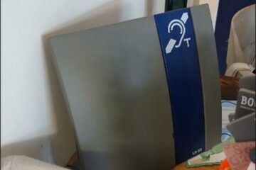 Photo of an induction loop placed on the counter by the till of the bookshop.