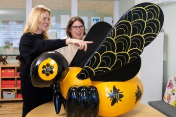 Sisters Jen and Lorna with one of the Buzz in the City bees that Lorna helped to paint at ECL Highfields.
