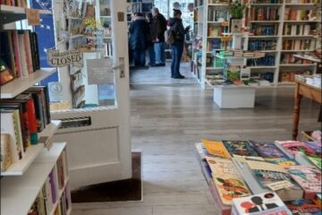 Interior photo of Maldon Books after the accessibility improvements - view from the right hand side of the store showing the inside of the door and a display table.