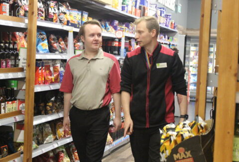 ECL customer James walking and talking with one of the Coop managers