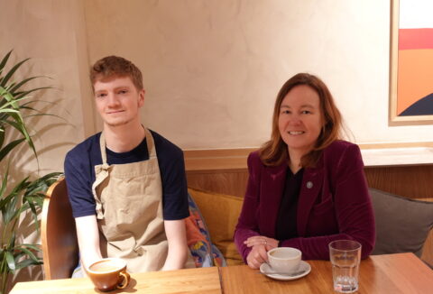A young man, Michael, sitting next to Marie Goldman, Colchester MP