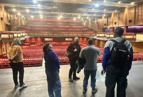 Group of young adults taking a tour of Cliffs Pavilion theatre.