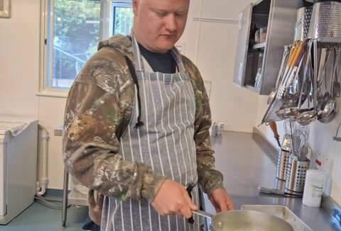 You man in a kitchen cooking