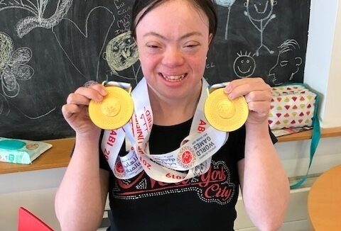 ECL customer Rosa showing off her gold medals