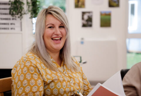 Jess Shorey laughing during a team meeting