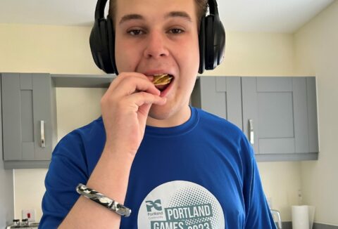 A young boy eating a biscuit.