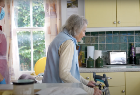 An elderly woman in a kitchen