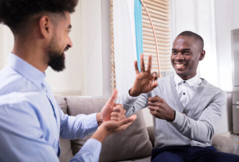 2 men using sign language to communicate