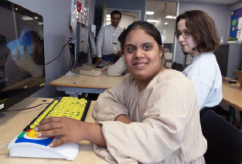 A woman typing on a keyboard