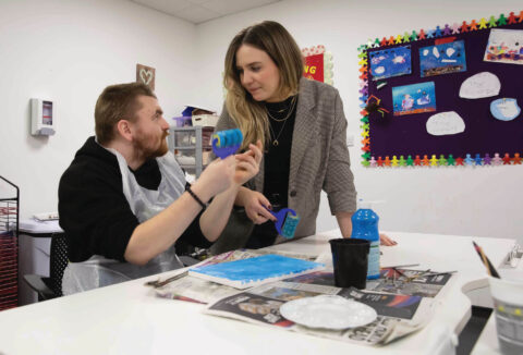 2 people talking at a table